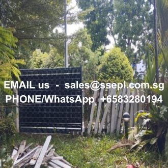 Solar panel in a overgrown garden with white text overlay showing contact info: sales@ssepl.com.sg and phone/WhatsApp +6583280194