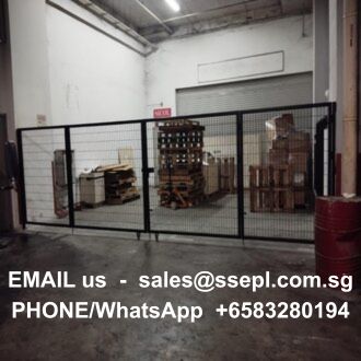 Warehouse with pallets and boxes behind a black metal gate; white text overlay shows a contact email and WhatsApp number