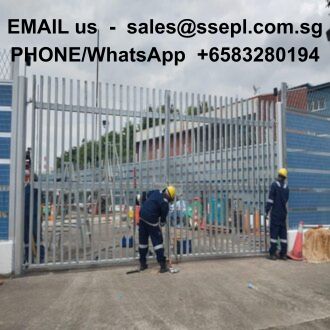 Two construction workers in blue uniforms and yellow helmets stand by a tall metal gate at a construction site; contact email and WhatsApp number are shown across the top.