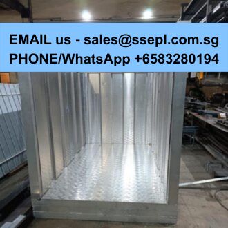 Empty stainless steel display cabinet on a workshop floor with a blue banner overhead showing sales contact information.